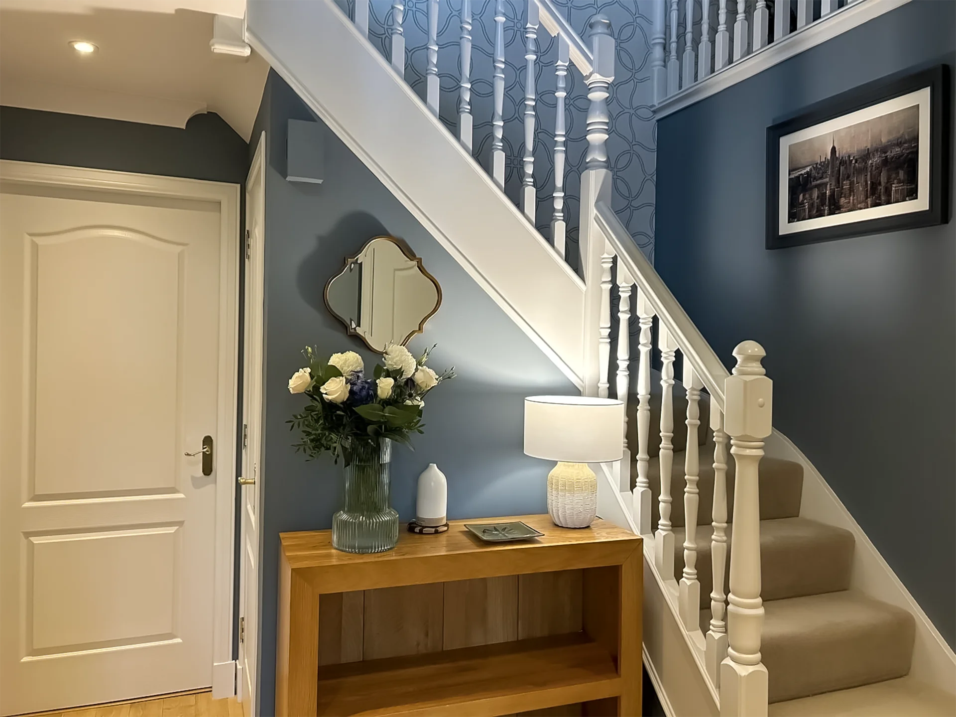 Hallway with console table and staircase